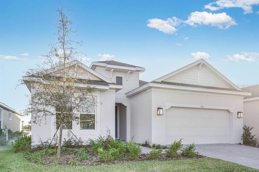 Front exterior of a new home in Esplanade at Center Lake Ranch, St. Cloud, FL, highlighting curb appeal (Image 2).