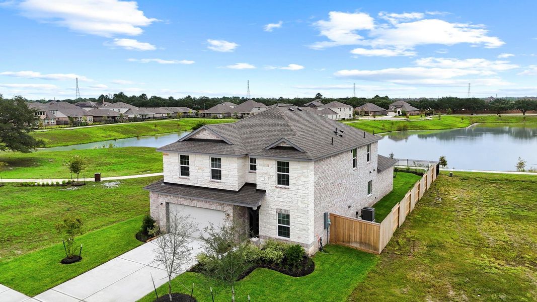 Aerial shot of the home and backyard highlights its corner lot placement and proximity to the lake—giving you the perfect blend of privacy and picturesque surroundings. Almost all brick home for less upkeep! Aerial shot of the home and backyard highlights its corner lot placement and proximity to the lake—giving you the perfect blend of privacy and picturesque surroundings. Almost all brick home for less upkeep!