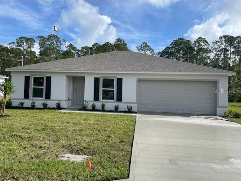 Front exterior of a new home in Palm Coast: Value Collection, Palm Coast, FL, highlighting curb appeal (Image 1). Front exterior of a new home in Palm Coast: Value Collection, Palm Coast, FL, highlighting curb appeal (Image 1).