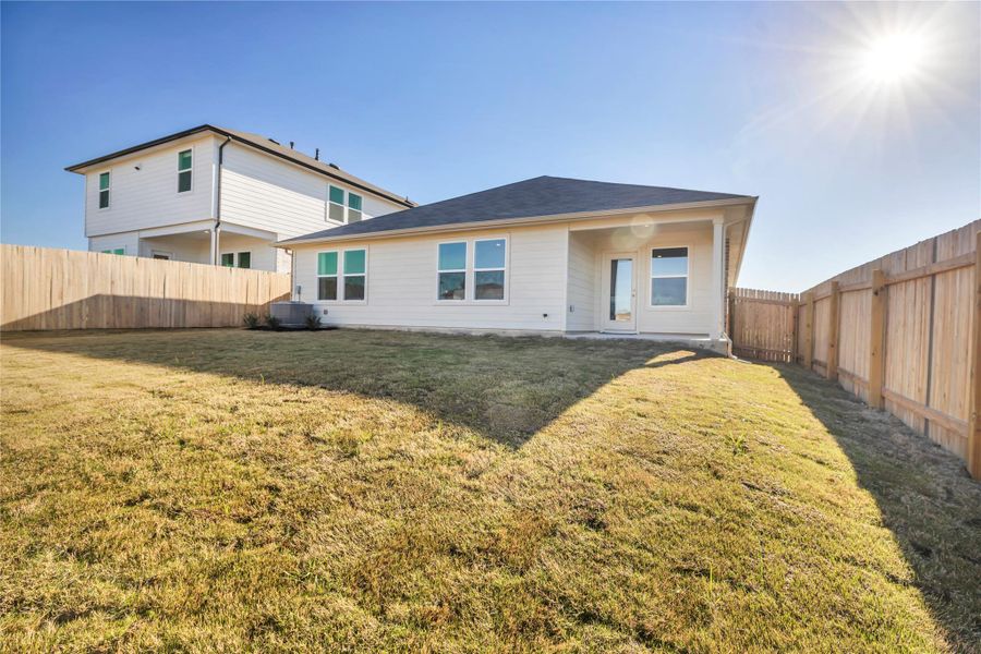 Front exterior of a new home in Carillon, Manor, TX, highlighting curb appeal (Image 2). Front exterior of a new home in Carillon, Manor, TX, highlighting curb appeal (Image 2).