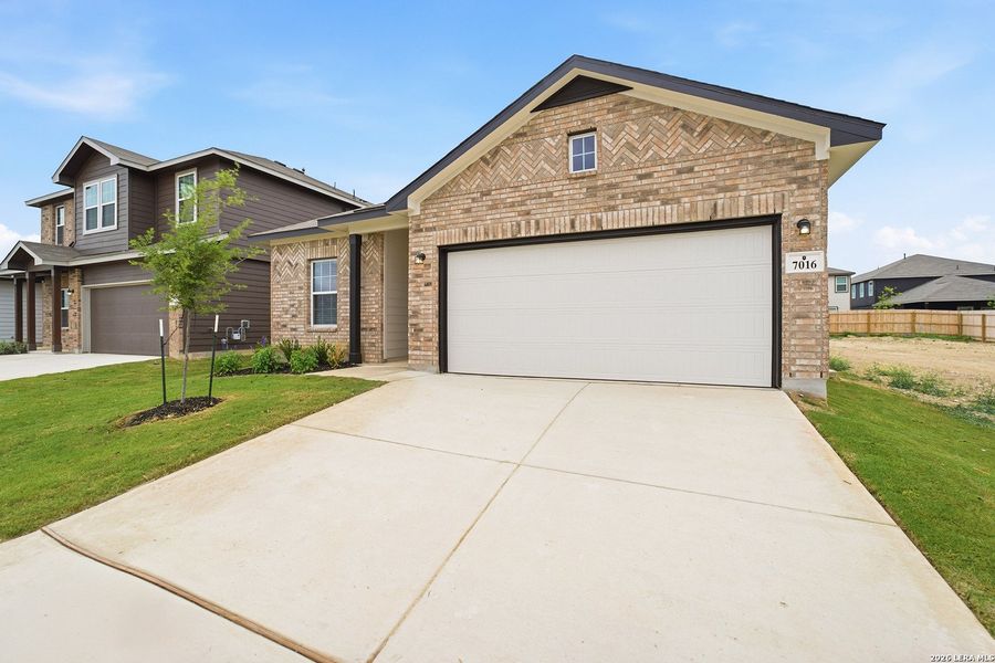 Front exterior of a new home in Hennersby Hollow, San Antonio, TX, highlighting curb appeal (Image 2). Front exterior of a new home in Hennersby Hollow, San Antonio, TX, highlighting curb appeal (Image 2).