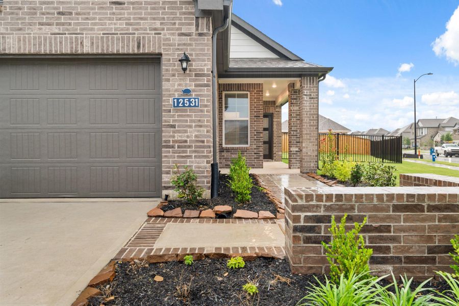Front exterior of a new home in Creekland Village at Bridgeland, Cypress, TX, highlighting curb appeal (Image 15). Front exterior of a new home in Creekland Village at Bridgeland, Cypress, TX, highlighting curb appeal (Image 15).
