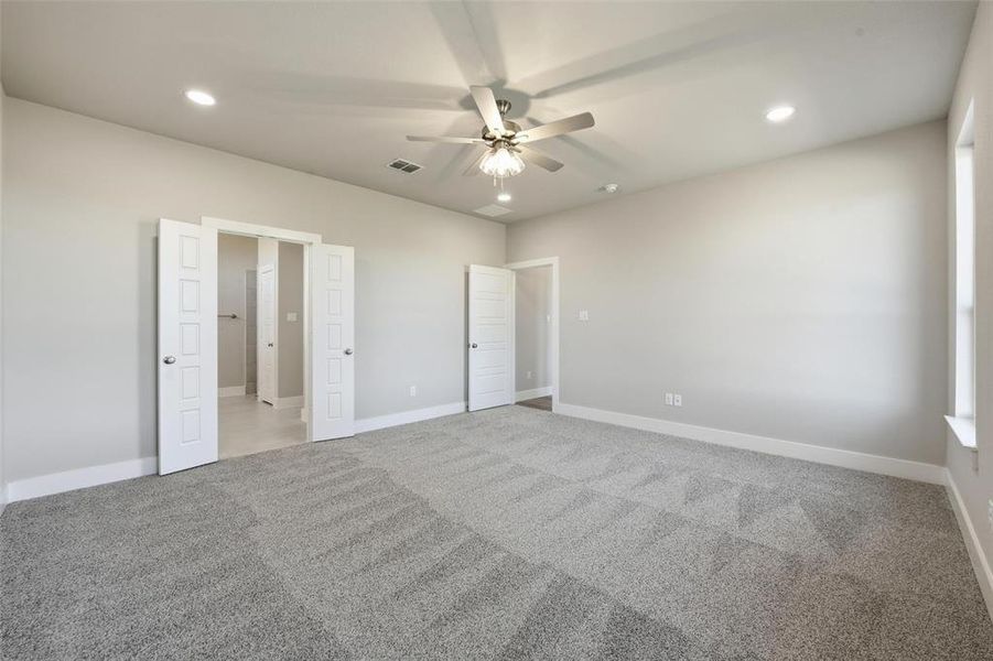 Unfurnished bedroom featuring recessed lighting, light colored carpet, and a ceiling fan