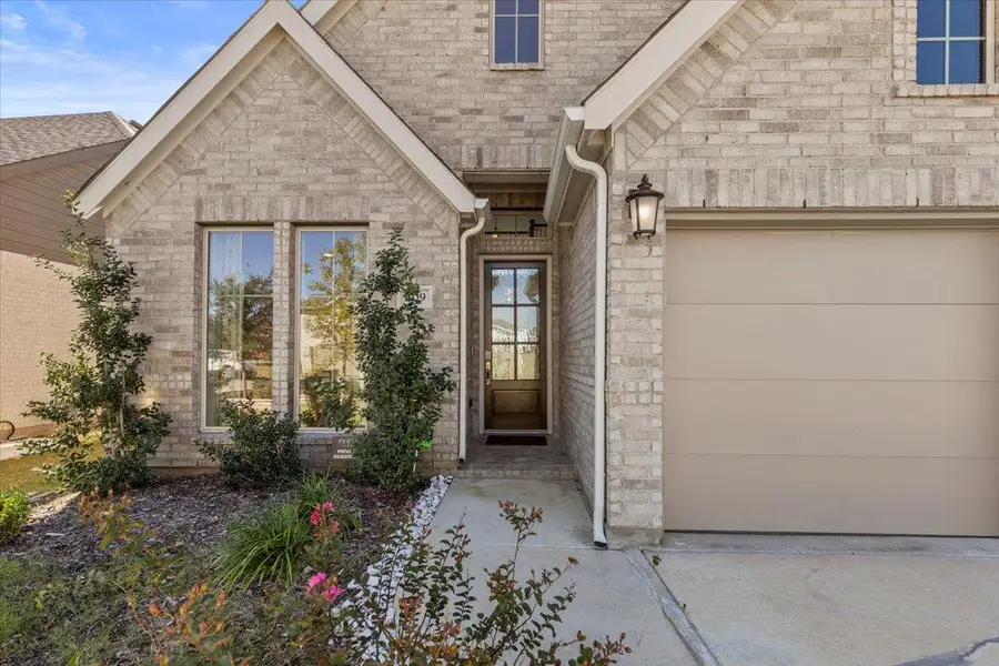 Doorway to property with a garage and brick siding Doorway to property with a garage and brick siding