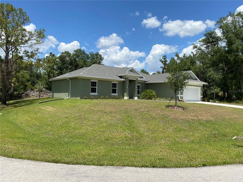 Front exterior of a new home in , North Port, FL, highlighting curb appeal (Image 2). Front exterior of a new home in , North Port, FL, highlighting curb appeal (Image 2).