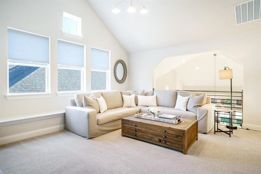 Light-Filled Loft Living - Another angle of the upstairs living area reveals custom windows and architectural cutouts that keep the space bright and connected. Light-Filled Loft Living - Another angle of the upstairs living area reveals custom windows and architectural cutouts that keep the space bright and connected.