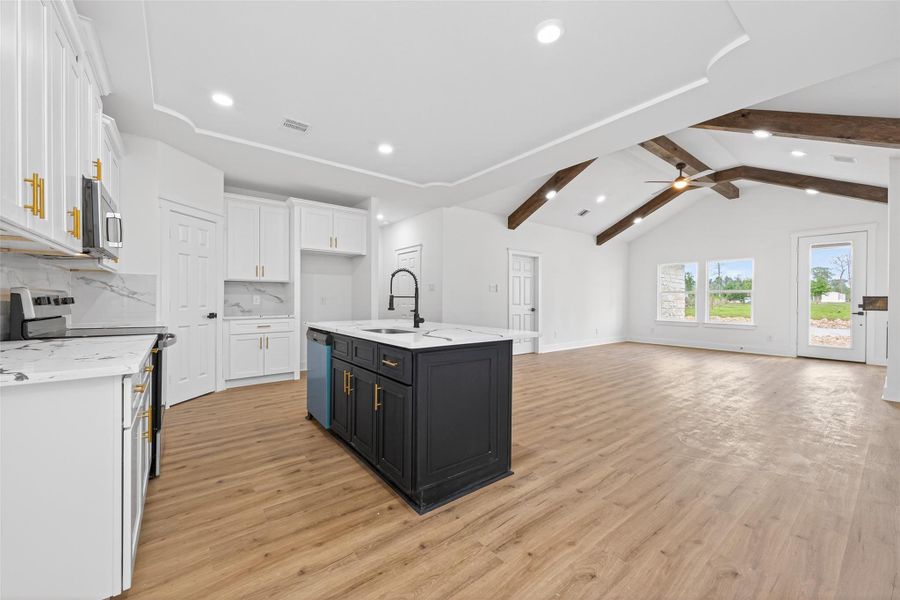 Expansive island overlooking the living area, perfect for gatherings and everyday functionality.