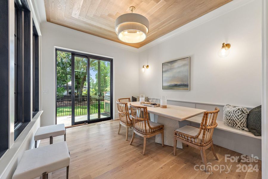 Breakfast room with built in bench and view of outdoor kitchen