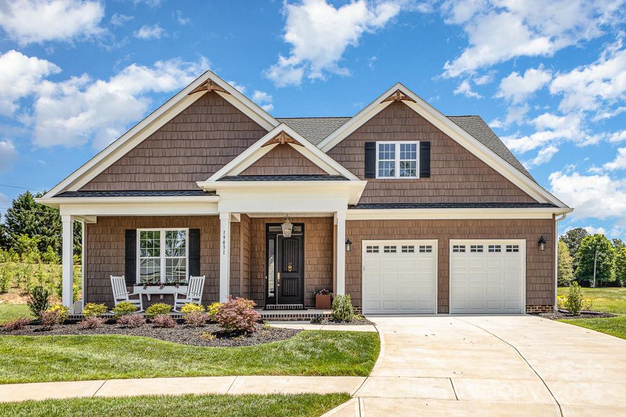 Lovely Carson model with wooden trim details in the gables and a shingled facade. Rocking chair front porch welcomes you. Lovely Carson model with wooden trim details in the gables and a shingled facade. Rocking chair front porch welcomes you.