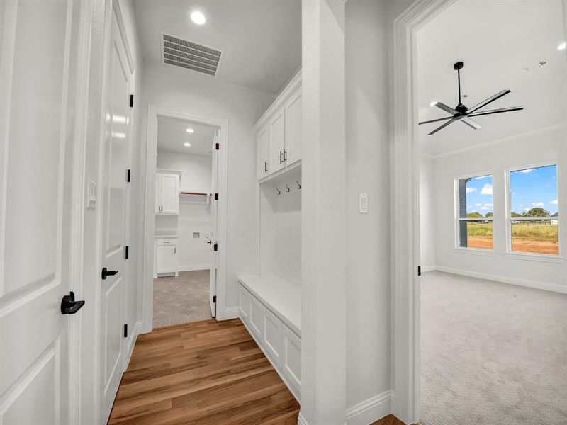 Mudroom featuring ceiling fan, light hardwood / wood-style flooring, and ornamental molding