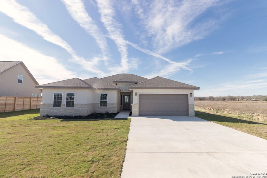 Front exterior of a new home in , La Vernia, TX, highlighting curb appeal (Image 18).
