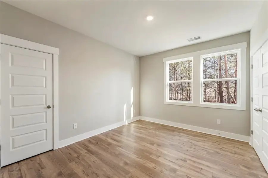 Hardwood floors and generous windows create a natu