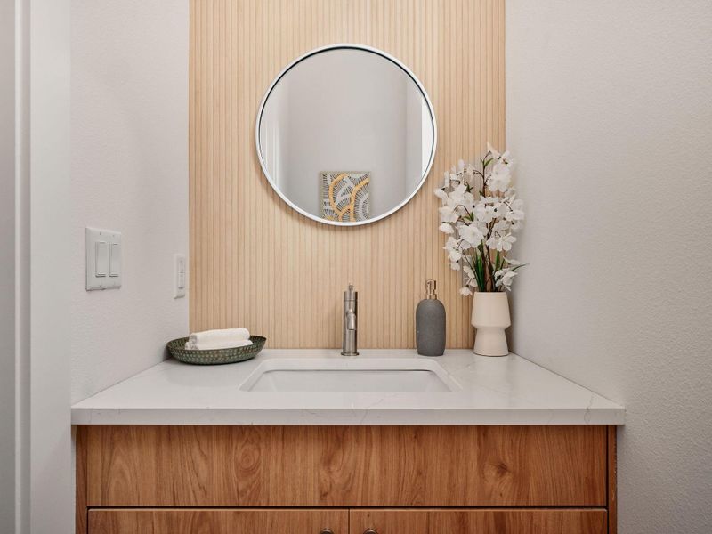 Bathroom featuring vanity and a textured wall