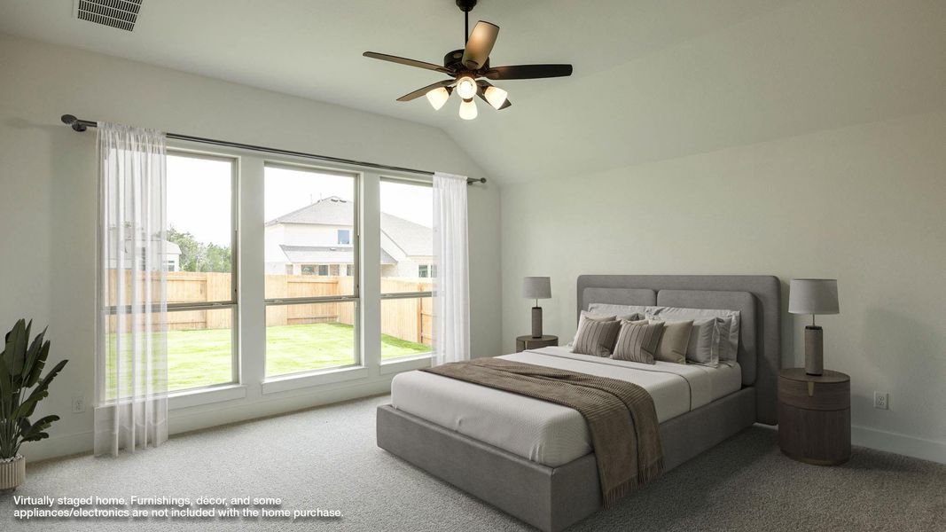 Carpeted bedroom featuring lofted ceiling and a ceiling fan