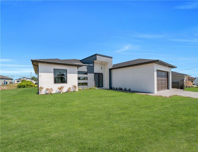 Front exterior of a new home in , Cape Coral, FL, highlighting curb appeal (Image 1). Front exterior of a new home in , Cape Coral, FL, highlighting curb appeal (Image 1).