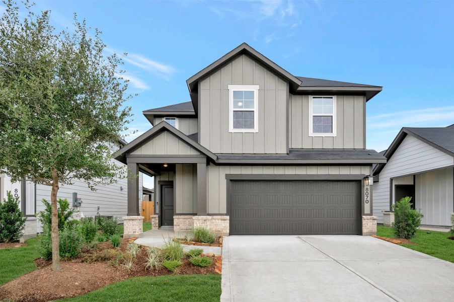 Front exterior of a new home in Mason Woods, Cypress, TX, highlighting curb appeal (Image 2). Front exterior of a new home in Mason Woods, Cypress, TX, highlighting curb appeal (Image 2).