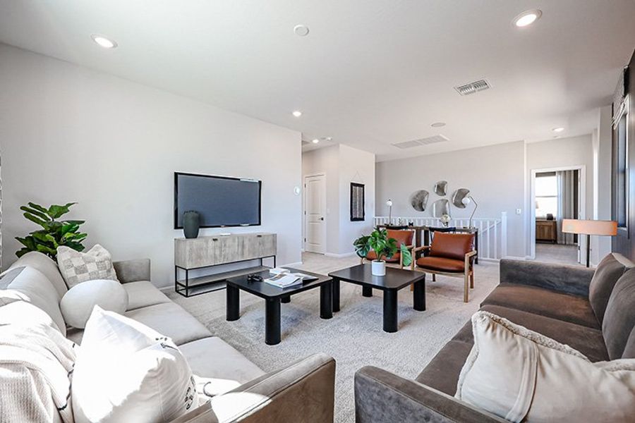 A living room with a tv and couches. A living room with a tv and couches.