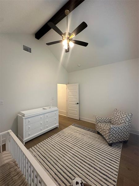 Vaulted ceiling with exposed wood beam and ceiling fan
