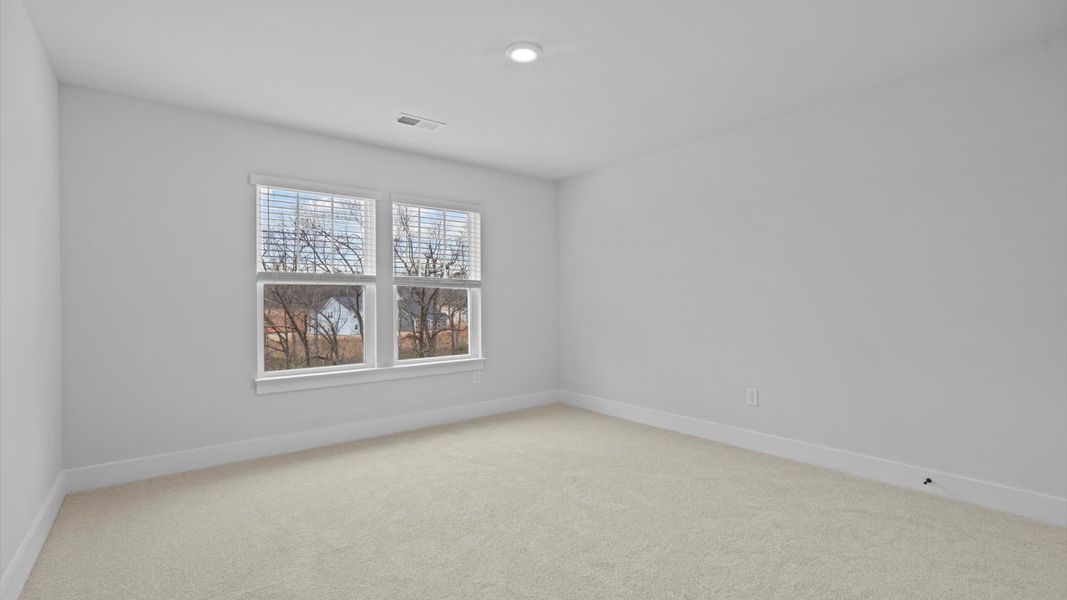 First-class bedroom with generous proportions, a walk-in closet, and beautiful natural light through large windows