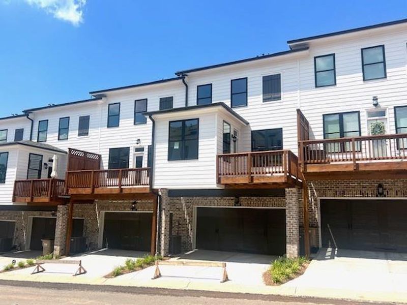 Front exterior of a new home in Palisades Townhomes, Cumming, GA, highlighting curb appeal (Image 31).