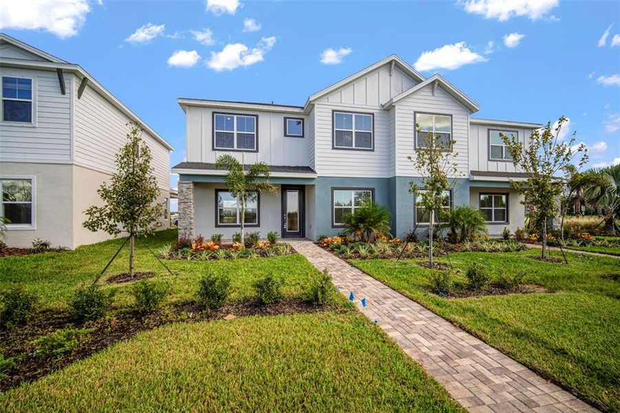 Front exterior of a new home in North River Ranch, Parrish, FL, highlighting curb appeal (Image 27).