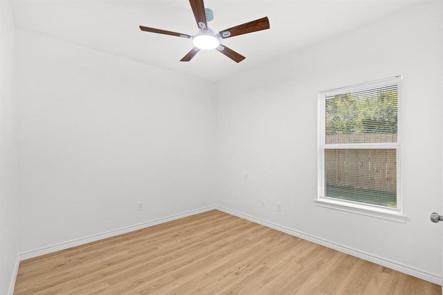 Empty room with light wood-style floors and ceiling fan Empty room with light wood-style floors and ceiling fan