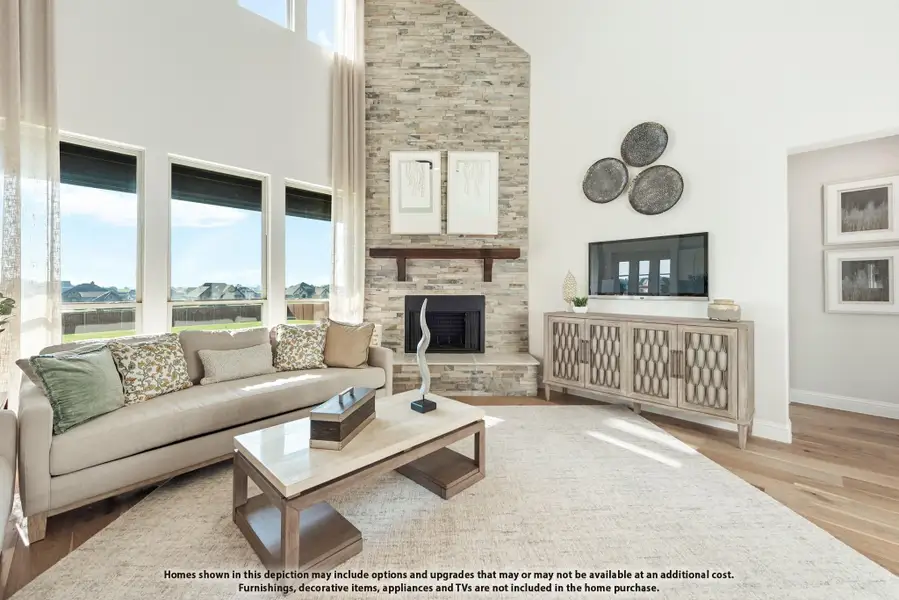 Living room with vaulted ceiling, floor-to-ceiling stone fireplace, large windows, and hardwood floors Living room with vaulted ceiling, floor-to-ceiling stone fireplace, large windows, and hardwood floors