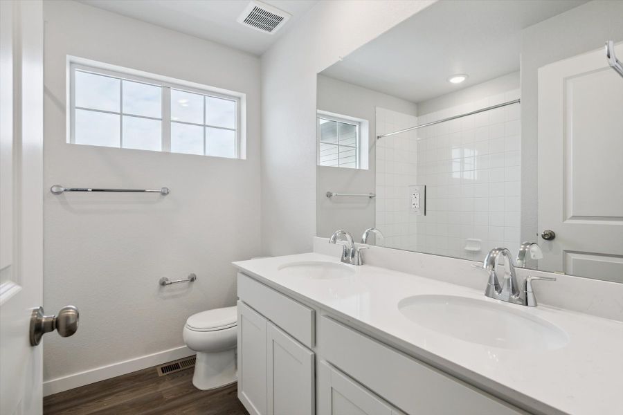 A bathroom with a large mirror.