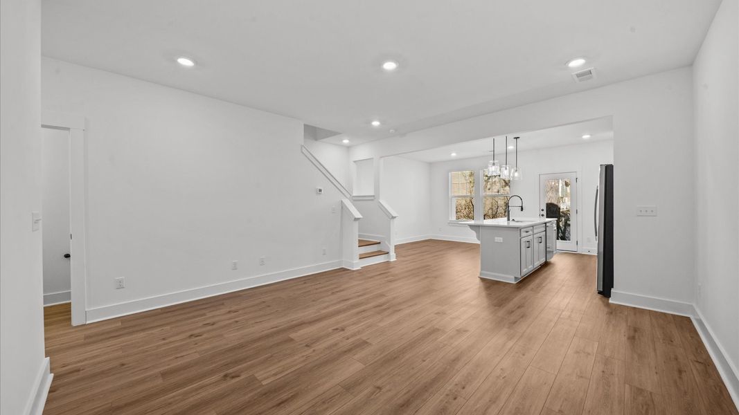 Vibrant and welcoming family room anchored by clean lines, tasteful materials, and abundant light at Clayton Crossing
