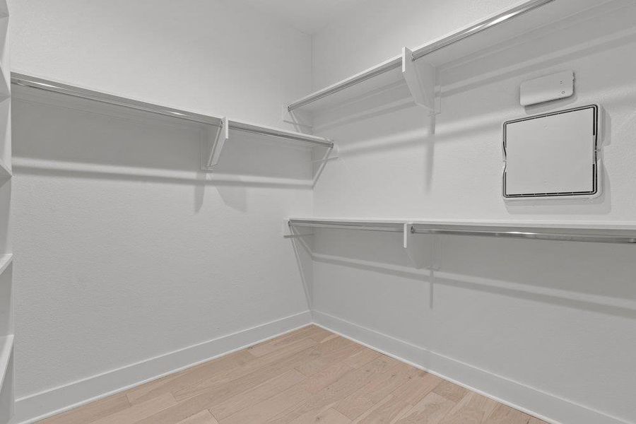 Ample built-in shelving and hanging rods maximize organization in this light-filled storage space. Ample built-in shelving and hanging rods maximize organization in this light-filled storage space.