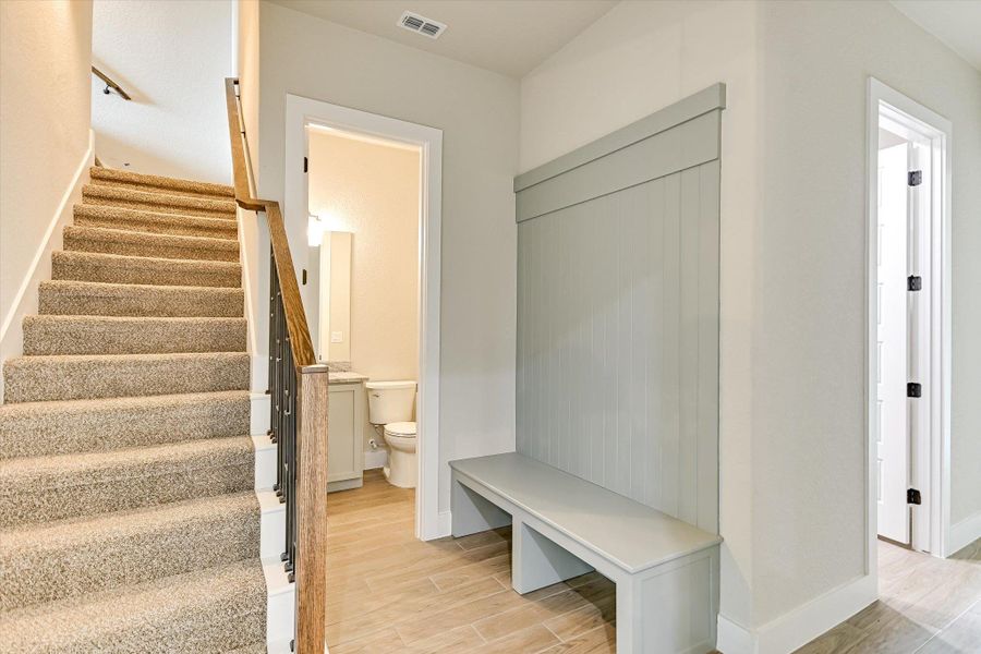 Mudroom featuring wood finish floors and baseboards