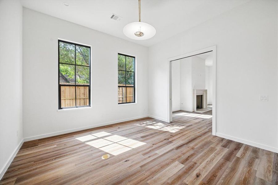 Bright and airy bonus room with large windows and pocket doors connecting to the living space, perfect for a home office/study, flex space, children's play room where the pocket doors can separate it from the common living area.