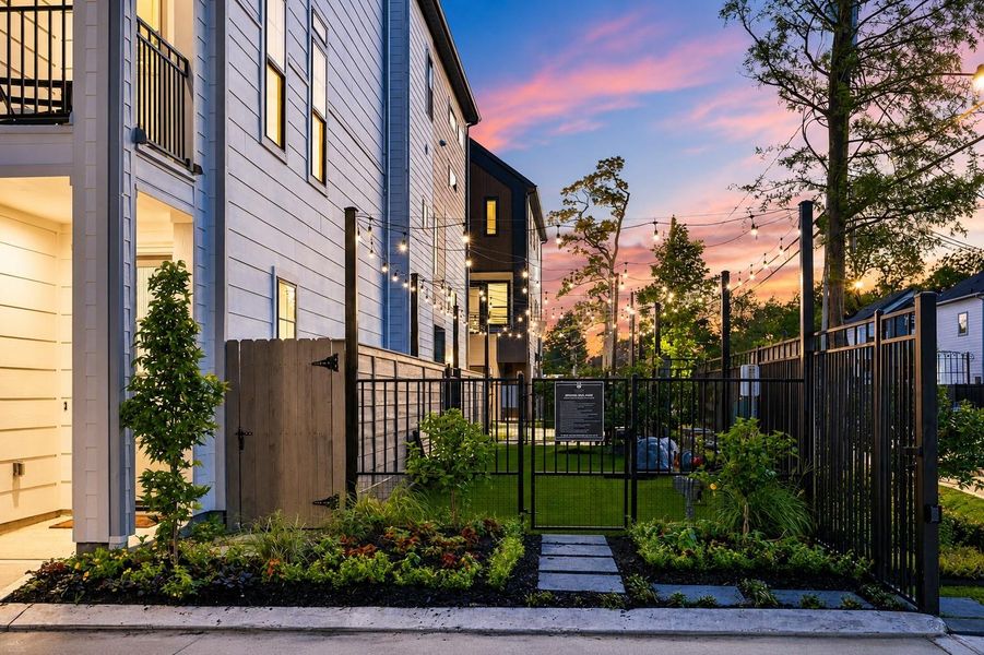 Inviting private green space with evening lighting and lush landscaping Inviting private green space with evening lighting and lush landscaping