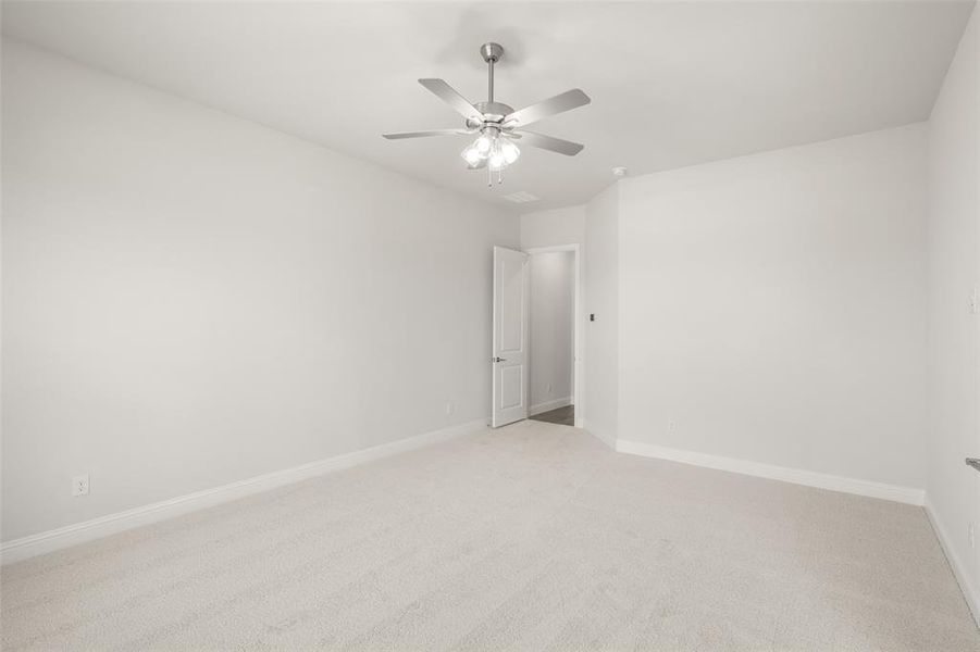 Unfurnished room featuring a ceiling fan and light colored carpet Unfurnished room featuring a ceiling fan and light colored carpet