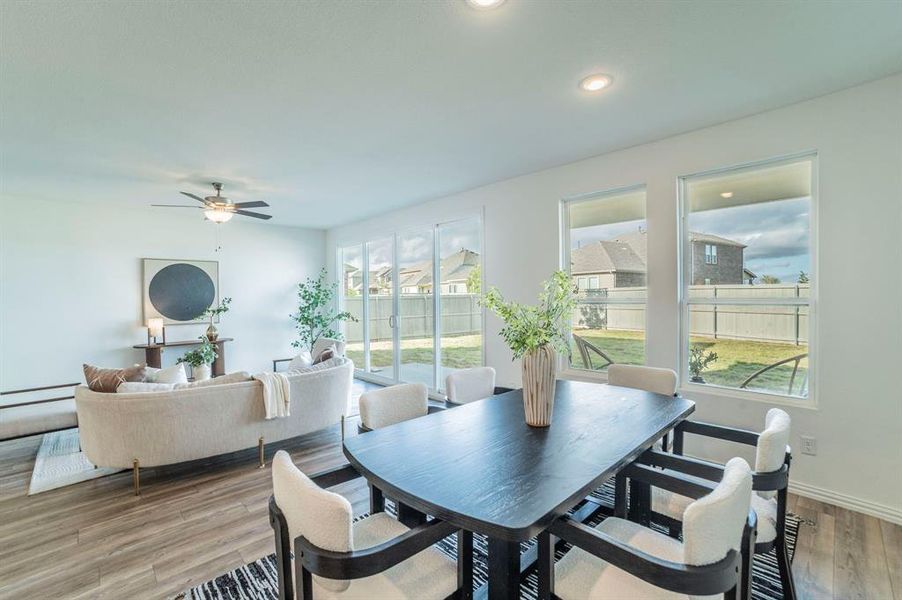Dining space with light wood-type flooring, a ceiling fan, and recessed lighting Dining space with light wood-type flooring, a ceiling fan, and recessed lighting