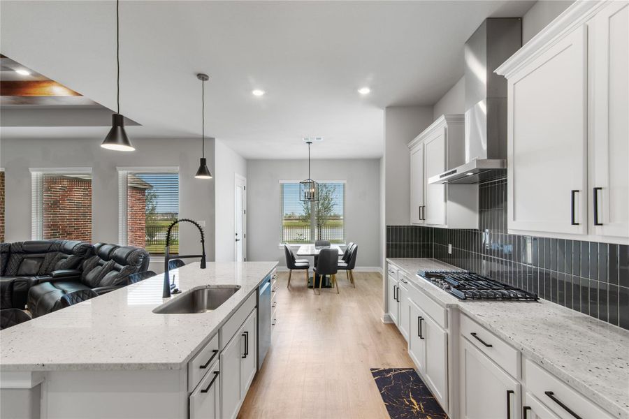 Experience a spacious open-concept area with a charming breakfast nook and stunning water views.