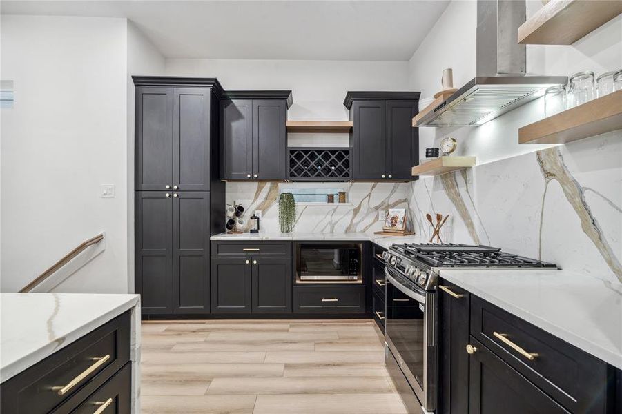 The kitchen is designed for both style and functionality, featuring a spacious pantry, ample cabinetry, and modern finishes that elevate the entire space.