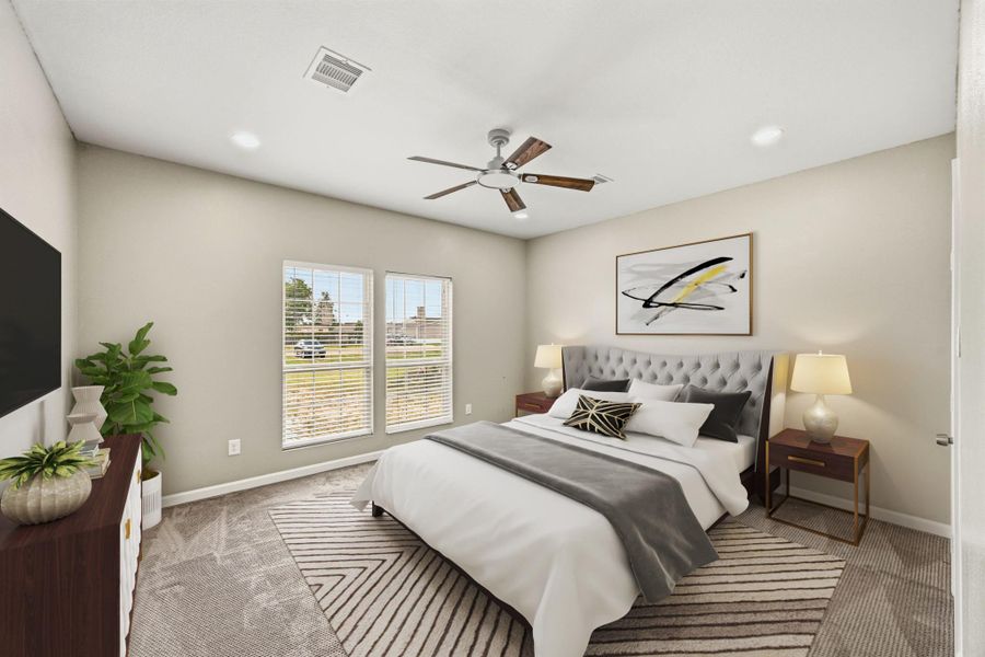 Virtually Staged: This inviting bedroom features a bright, airy layout with soft neutral tones and plush carpeting that adds warmth and comfort. Large windows allow natural light to pour into the space, creating a cheerful and welcoming atmosphere. Recessed lighting and a modern ceiling fan provide both style and functionality.