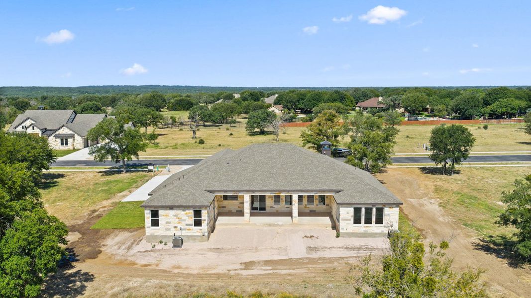 An aerial perspective reveals a newly constructed residence, integrating with the rolling landscape and surrounding natural environment. An aerial perspective reveals a newly constructed residence, integrating with the rolling landscape and surrounding natural environment.