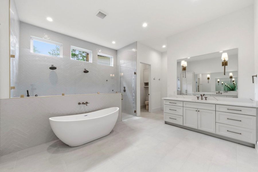 Spa-like primary bath with serene design details. Spa-like primary bath with serene design details.