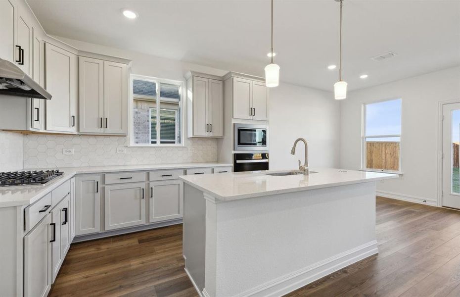 Bright kitchen with oversized island *real home pictured