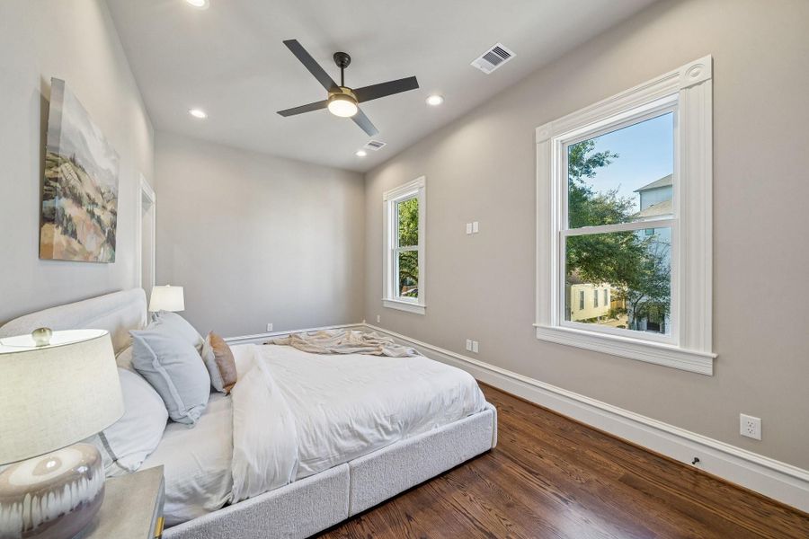 Second floor PRIMARY bedroom looking out onto the side of the home (Johnson St) where there are views of the 100+ year live oak trees Second floor PRIMARY bedroom looking out onto the side of the home (Johnson St) where there are views of the 100+ year live oak trees