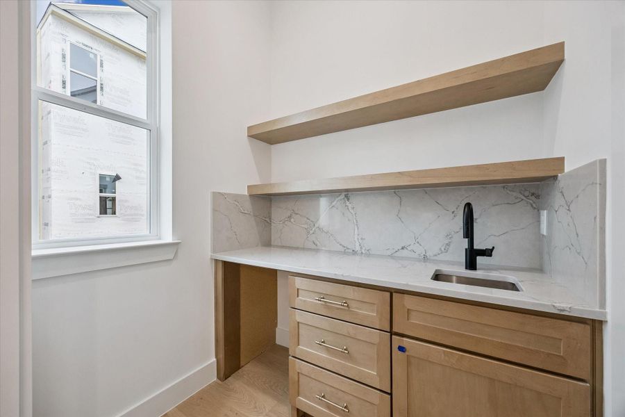 Elegant butler’s pantry offering additional storage and prep space perfect for entertaining and keeping the main kitchen organized.