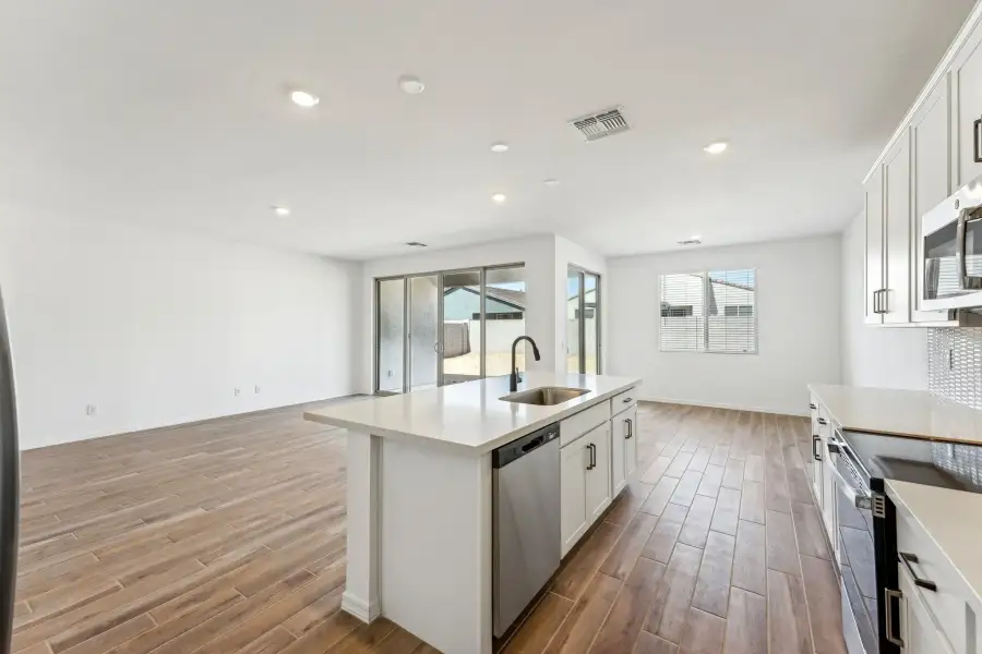 Great room, kitchen and dining. Finishes vary by community