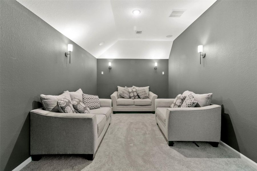 Transform your entertainment experience in this cozy media room, perfect for movie nights and relaxation.