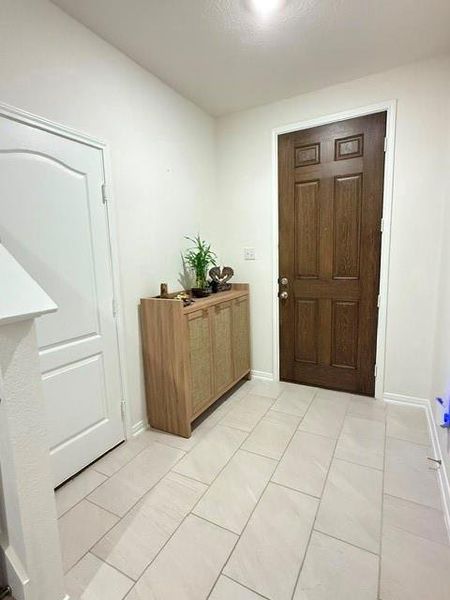 Welcoming foyer with large tile flooring and convenient entry storage. Welcoming foyer with large tile flooring and convenient entry storage.