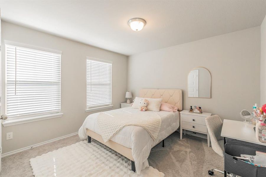 Bedroom featuring carpet flooring and baseboards