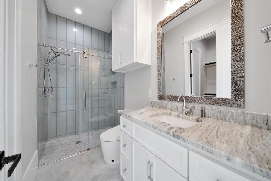 Downstairs Secondary Bathroom ensuite is just as luxurious as the primary. Complete with walk-in closet and custom designed shelving. Downstairs Secondary Bathroom ensuite is just as luxurious as the primary. Complete with walk-in closet and custom designed shelving.