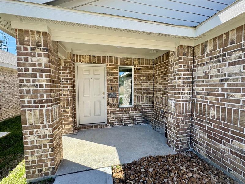 Covered porch entry. House is built with 3 sided brick and hardy plank.