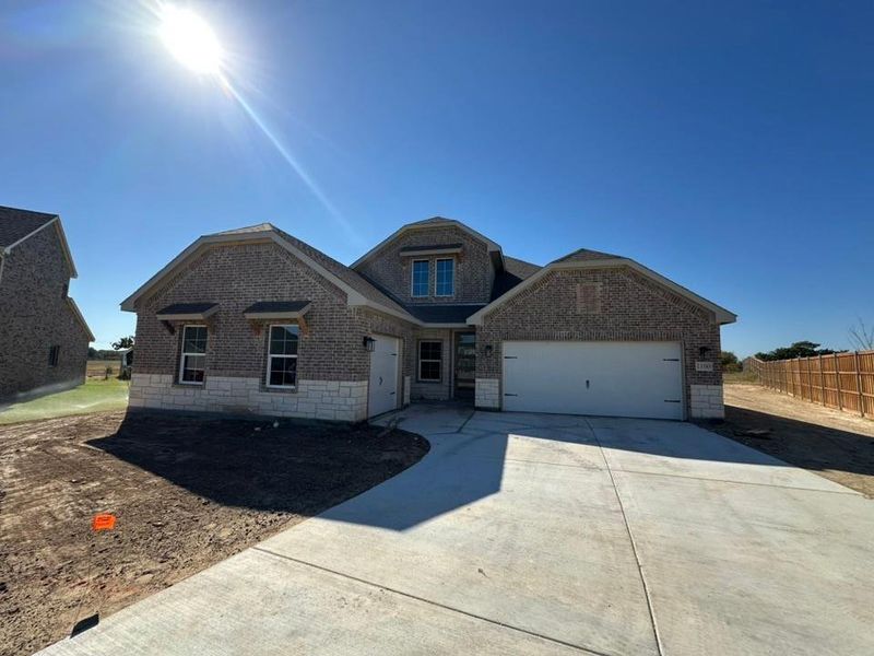 Front exterior of a new home in Covenant Springs, Springtown, TX, highlighting curb appeal (Image 1).